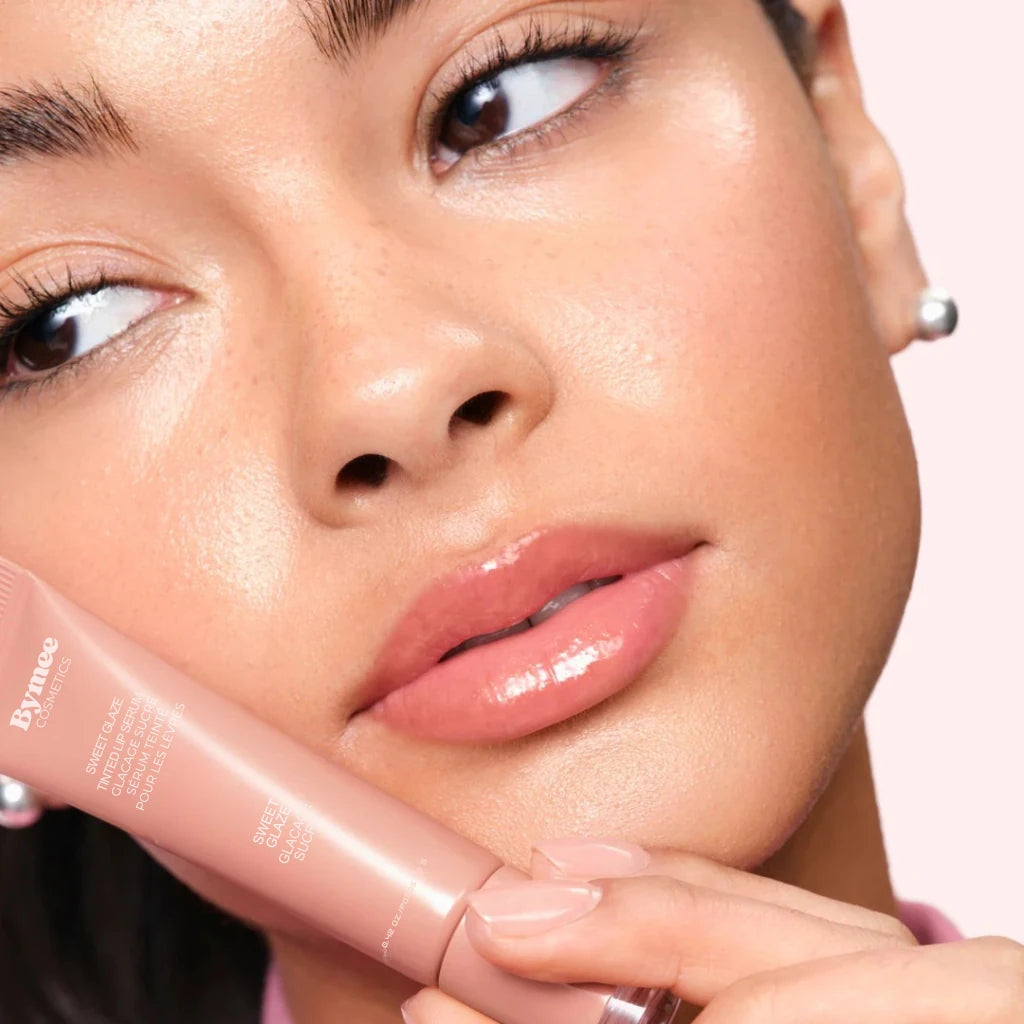 sweet-glaze-woman-holding-lip-serum.webp